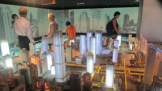 People looking at a model cityscape