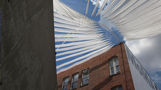 Cloth streamers strung from a roof, making a canopy of sorts
