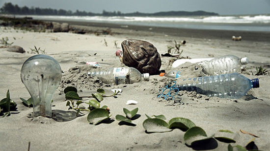 Photograph of garbage embedded on a beach