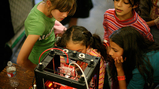 Kids watching a 3D printer at work