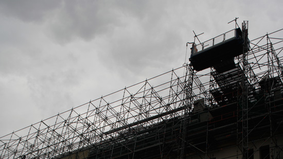 A view upward toward the silhouette of scaffolding
