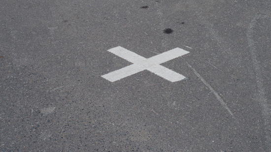 Parking space with a white X painted in it