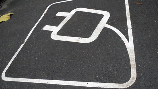 A parking spot with an electrical plug painted in it