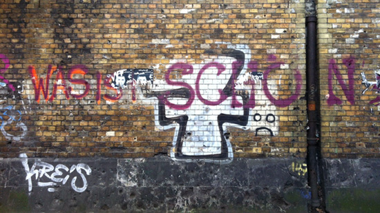 Graffiti on a wall that asks, 