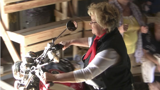 Photograph of a woman on a motorcycle