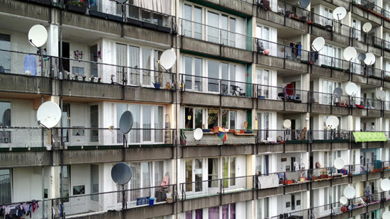 Balconies in an apartment block with many satellite dishes