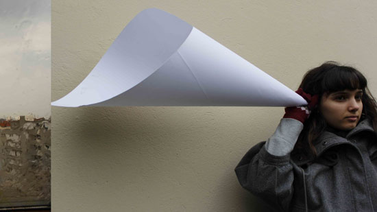 Woman using a paper ear-trumpet