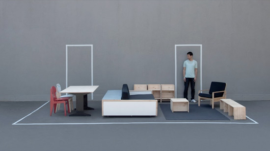 A man standing in living room furniture laid out in empty space