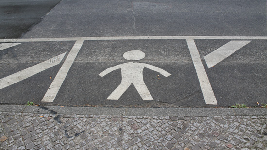 A parking spot with a pedestrian symbol painted in it