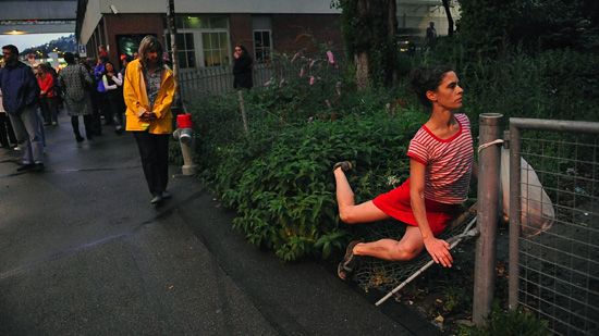 A woman performing gymnastics on a fence